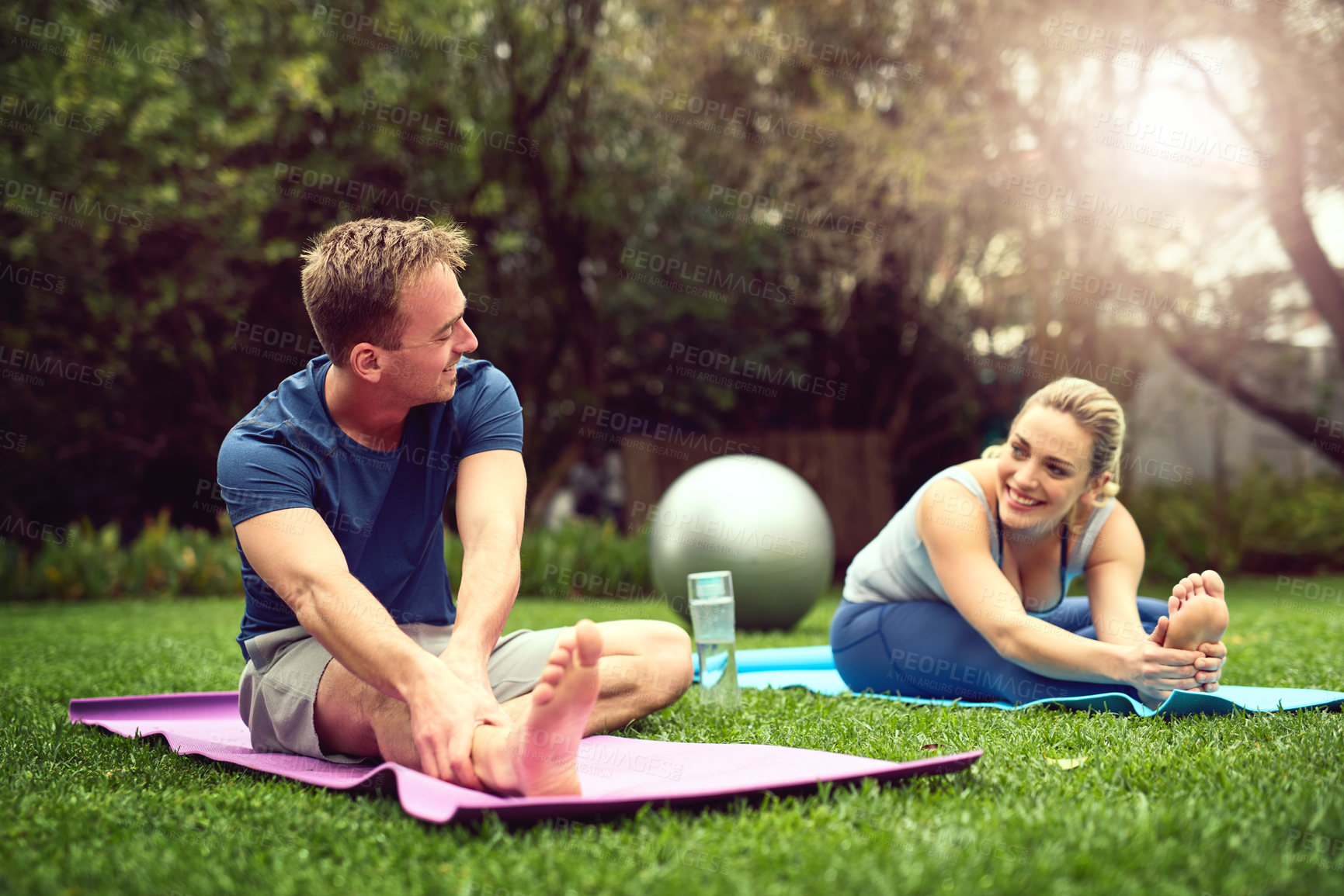 Buy stock photo Happy couple, stretching and yoga with mat for exercise, outdoor workout or training together on grass field. Young, man and woman with smile in backyard for pilates, warm up or fitness in nature