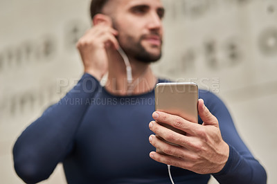 Buy stock photo Man, fitness and phone with earphones for audio, music or listening to online subscription or streaming. Young, active or male person thinking with headphones on mobile smartphone for sound podcast