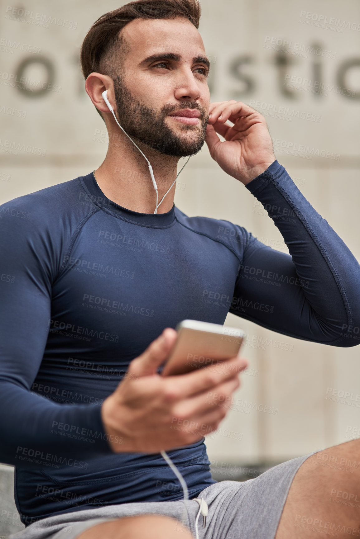 Buy stock photo Man, fitness and phone with earphones for podcast, music or listening on audio subscription or streaming. Young, active or male person thinking with headphones or mobile smartphone for sound playlist