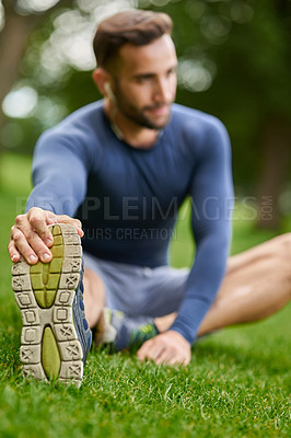 Buy stock photo Nature, foot and man stretching legs with mobility for fitness, workout or running outdoor. Sneakers, health and male athlete with warm up exercise on grass for cardio, sports or training in park.