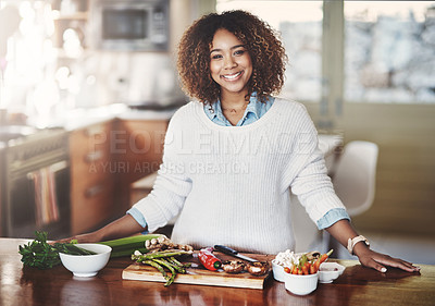 Buy stock photo Happy woman cooking healthy food from diet meal plan on home kitchen table for wellness lifestyle. Beautiful, confident female, smiling while making preparations for dinner with fresh ingredients.
