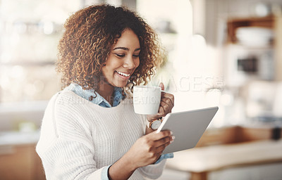 Buy stock photo Relaxed, happy and carefree black woman reading social media or news while having coffee at home. Smiling African American female enjoying a quiet morning streaming online or browsing the internet