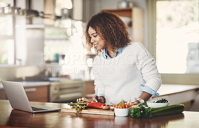 Buy stock photo Woman cooking new recipe from the internet preparing a vegetarian dinner, lunch or snack in a kitchen at home. One food or culinary student trying an online vegetable, vegan or healthy green dish