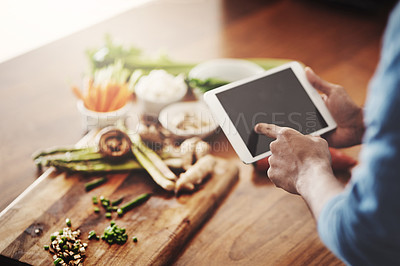 Buy stock photo Closeup of hands of man holding a tablet to research healthy recipes, watch cooking tutorial videos and scrolling online for meal ideas while making dinner, lunch or breakfast. Man browsing on app