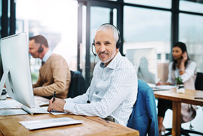 Buy stock photo Cropped portrait of a handsome mature male operator working at his desk