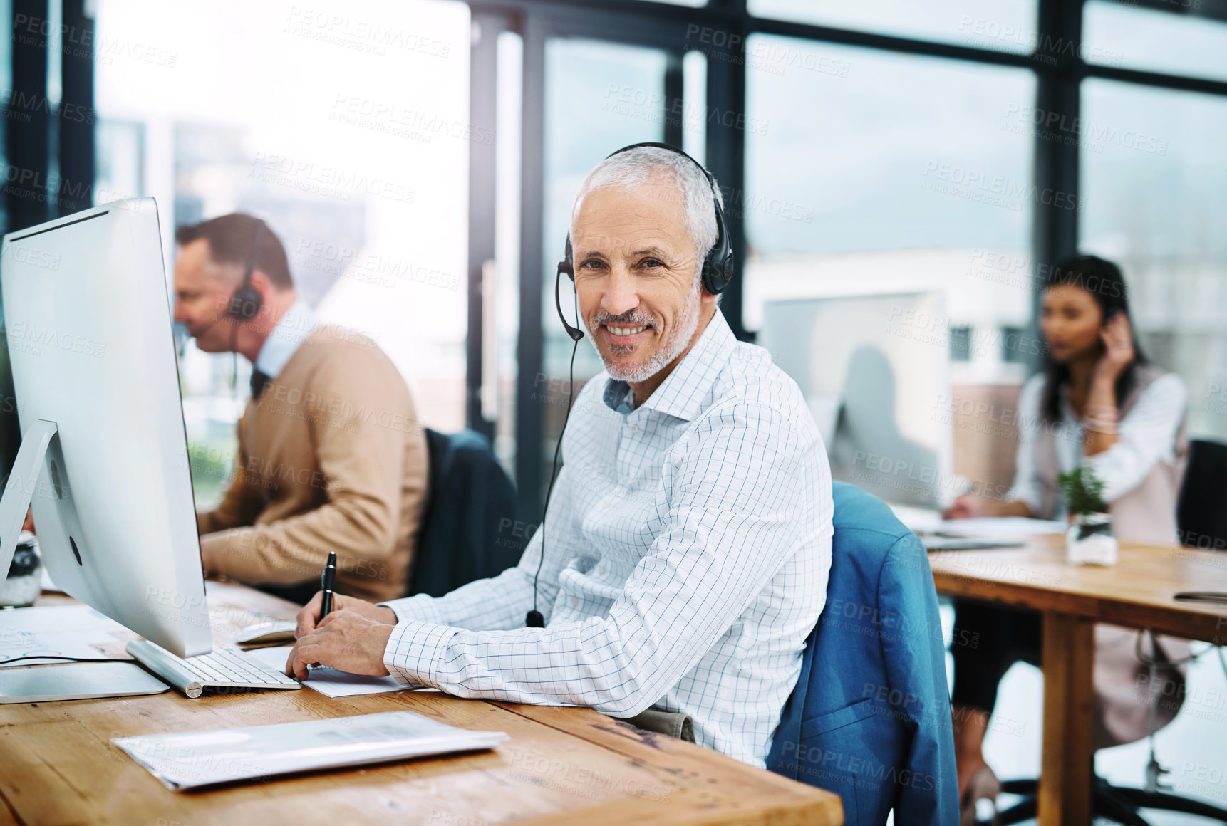 Buy stock photo Mature man, portrait and call centre operator in coworking office, crm and consultant for support. Male person, headset and telemarketer for sale service, writing notes and information for assistance