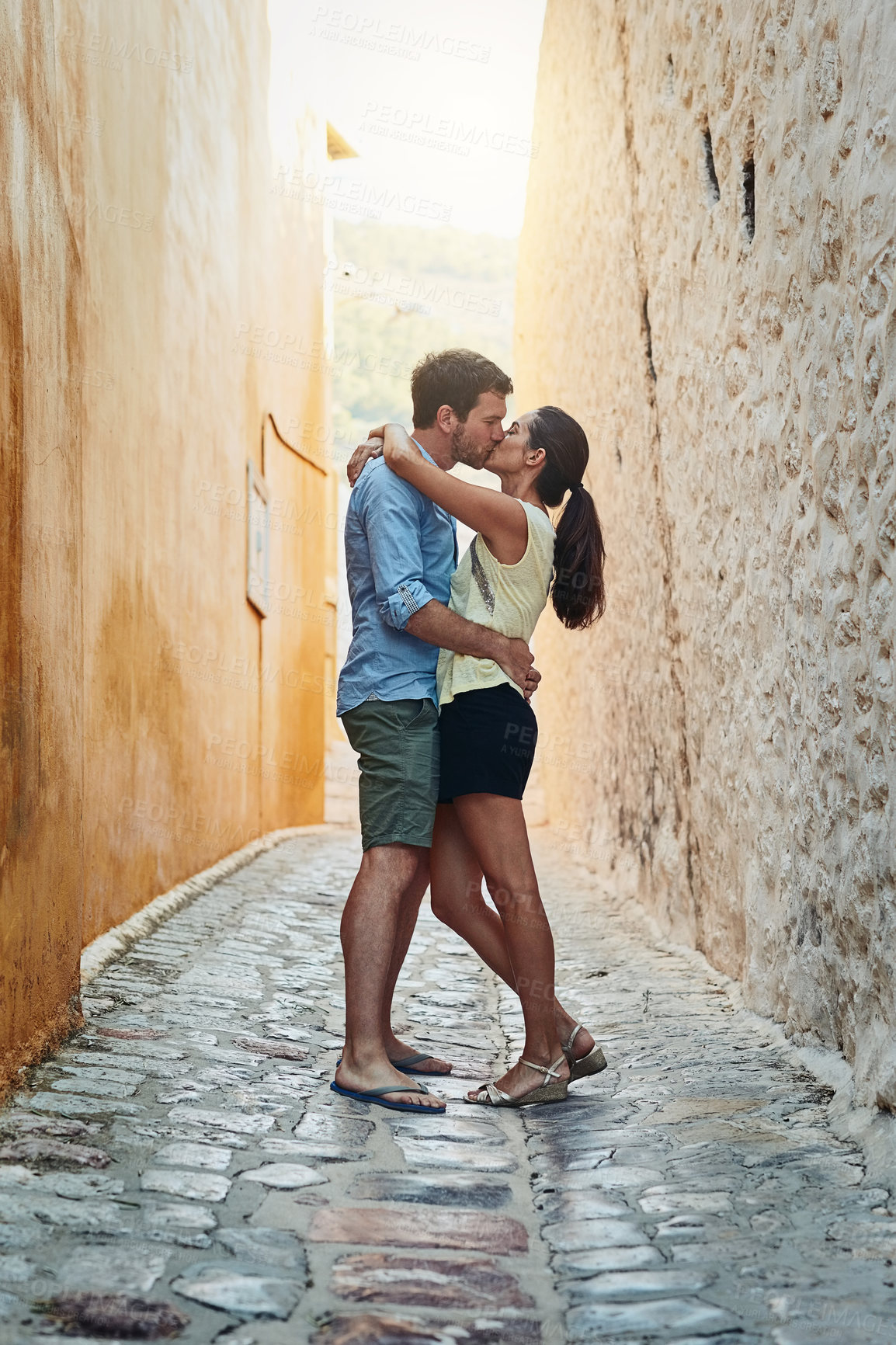 Buy stock photo Couple, kiss and hug in city on holiday, marriage commitment and travel to Egypt. People, outdoor tourism and support for security in relationship, romance and embrace on honeymoon weekend trip