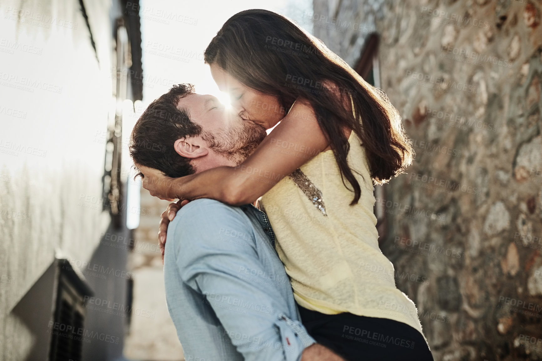 Buy stock photo Shot of an affectionate couple kissing outside