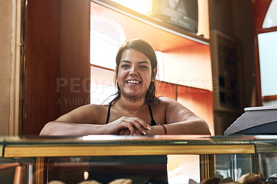 Buy stock photo Cropped shot of a young woman working in her bakery