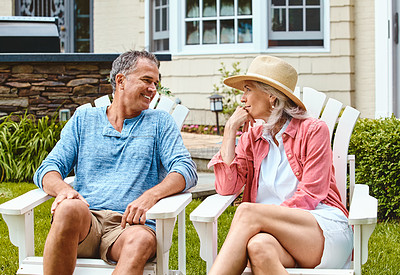 Buy stock photo Mature couple, garden and outdoor on chair to relax with funny memory, bonding and conversation with love at house. Man, woman and talking with laugh, retirement and chat for summer in home backyard