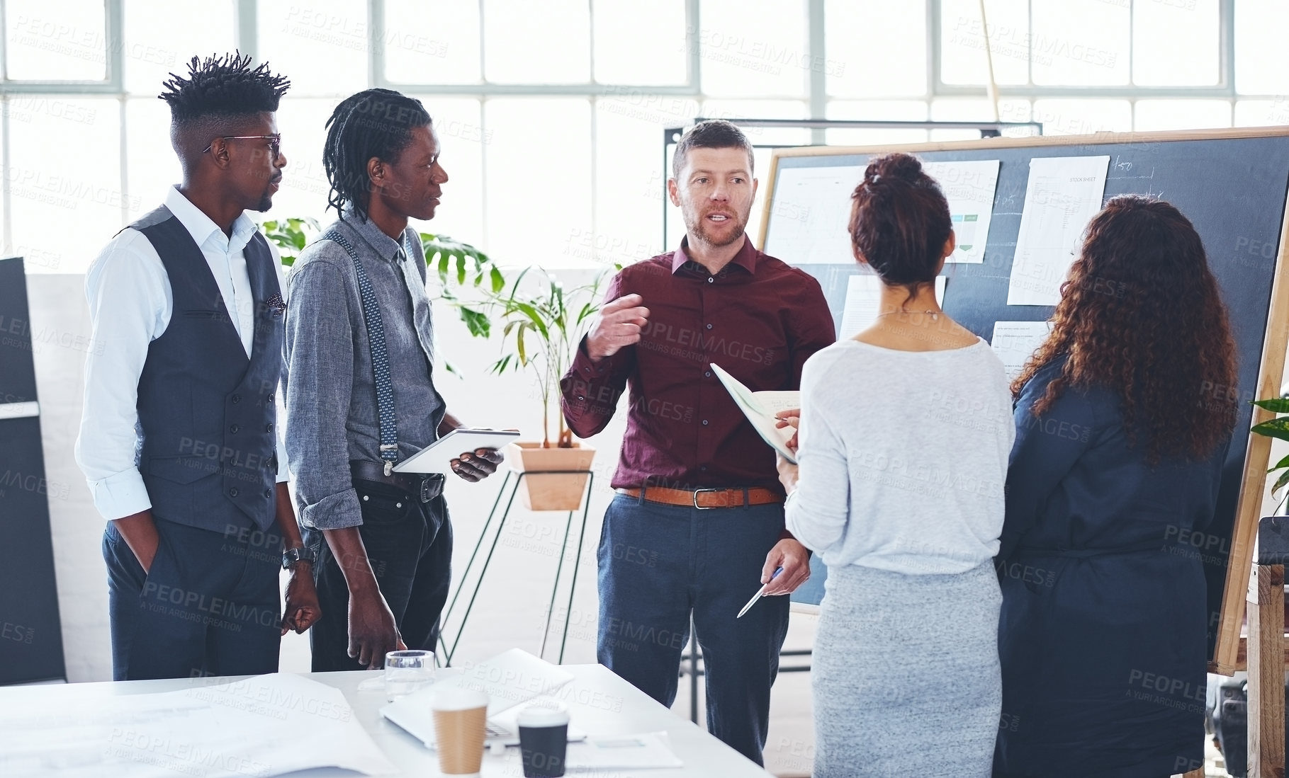 Buy stock photo Shot of a group of businesspeople brainstorming in an office