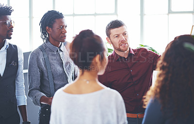 Buy stock photo Shot of a group of businesspeople brainstorming in an office