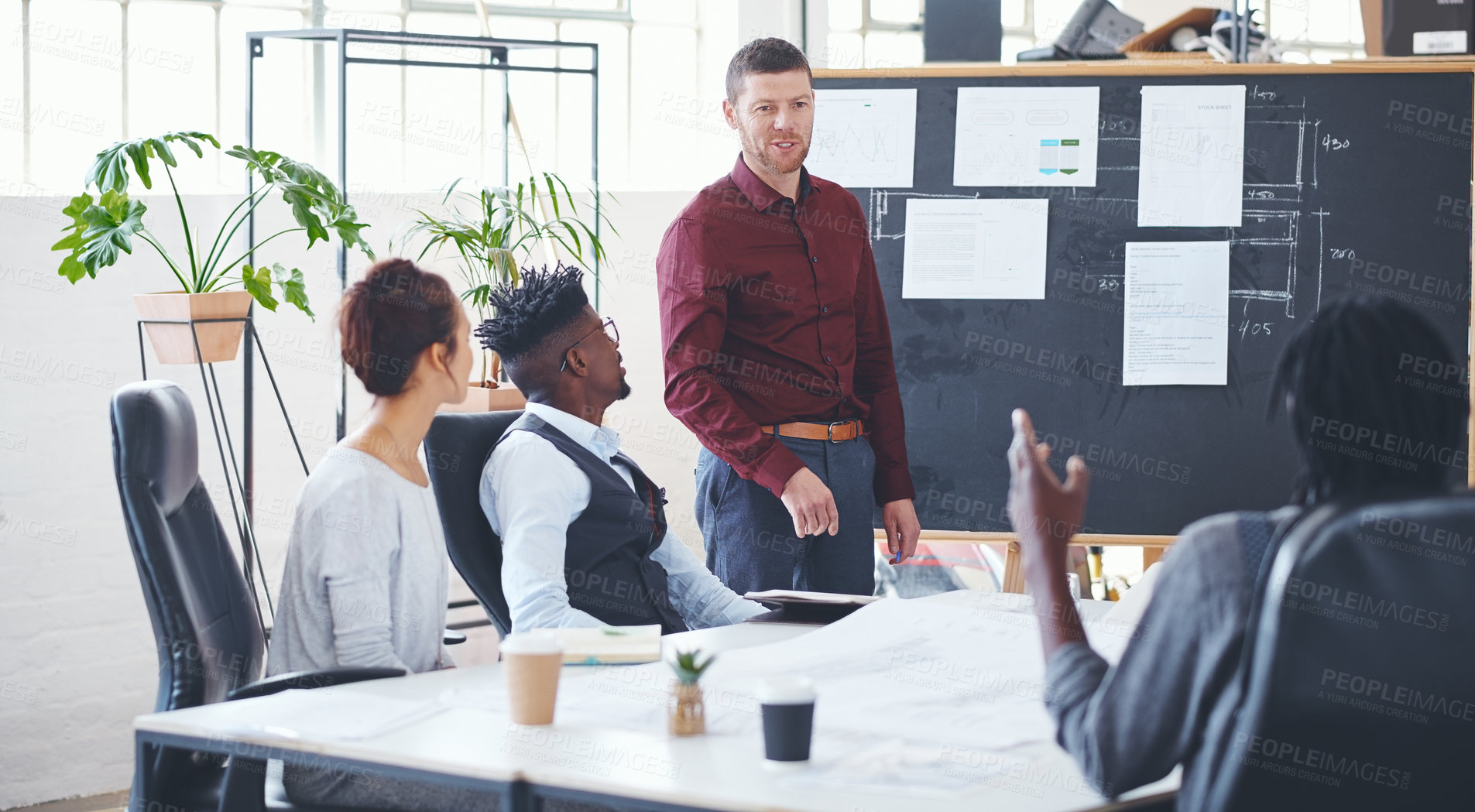 Buy stock photo Shot of a businessman giving a presentation to his colleagues in an office