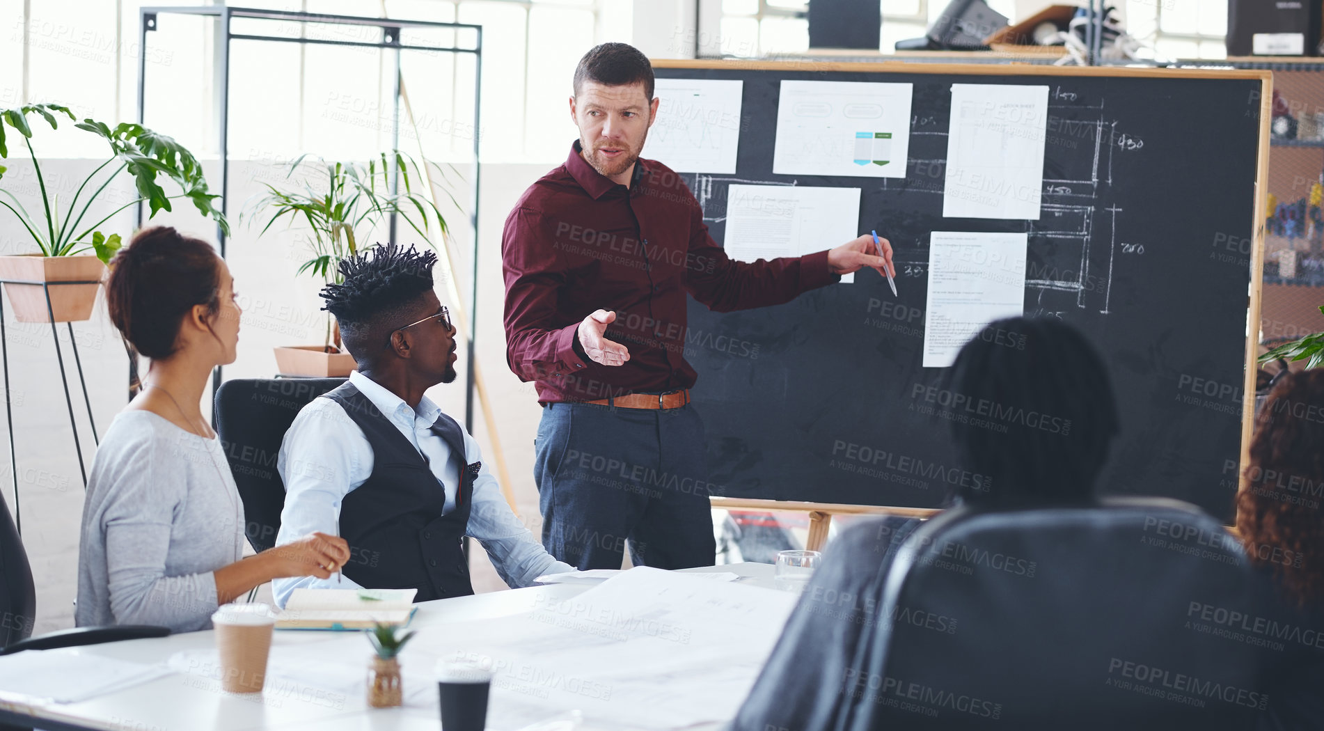 Buy stock photo Shot of a businessman giving a presentation to his colleagues in an office