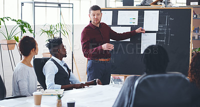 Buy stock photo Shot of a businessman giving a presentation to his colleagues in an office