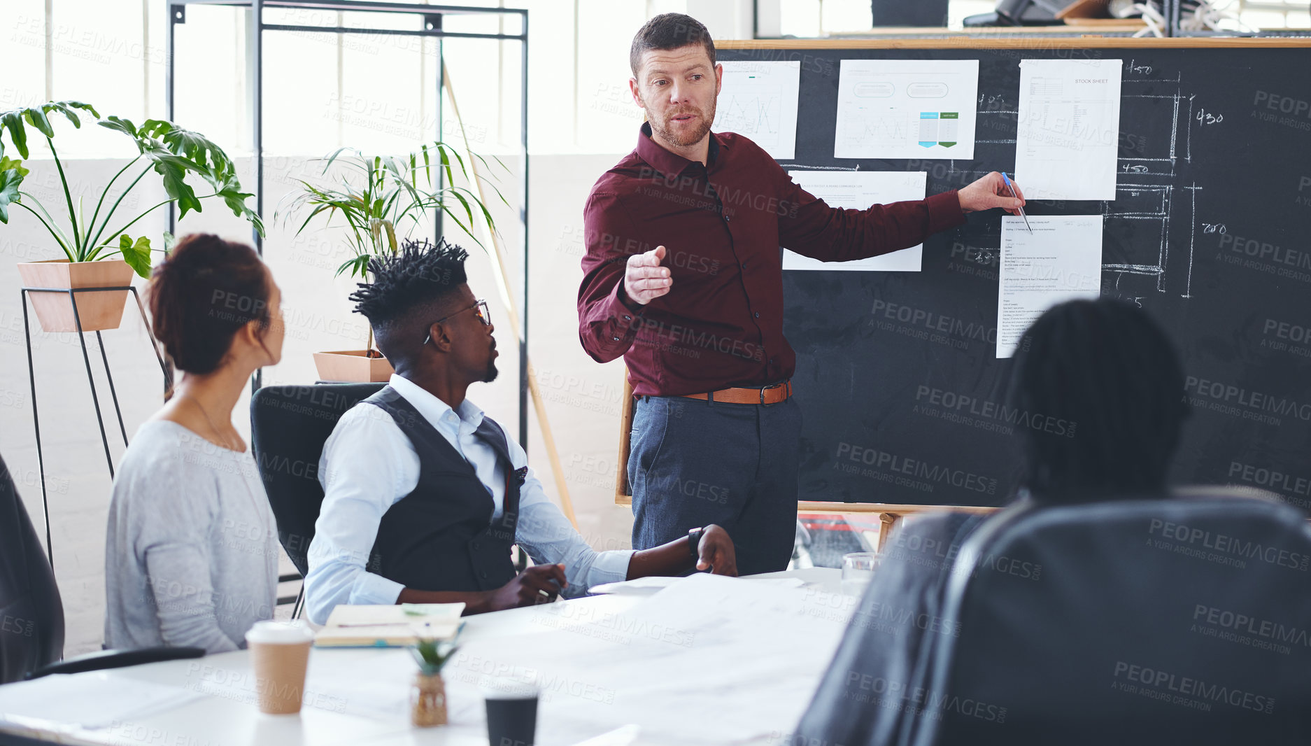 Buy stock photo Shot of a businessman giving a presentation to his colleagues in an office