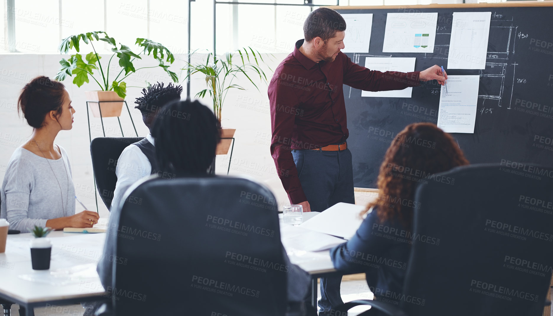 Buy stock photo Shot of a businessman giving a presentation to his colleagues in an office