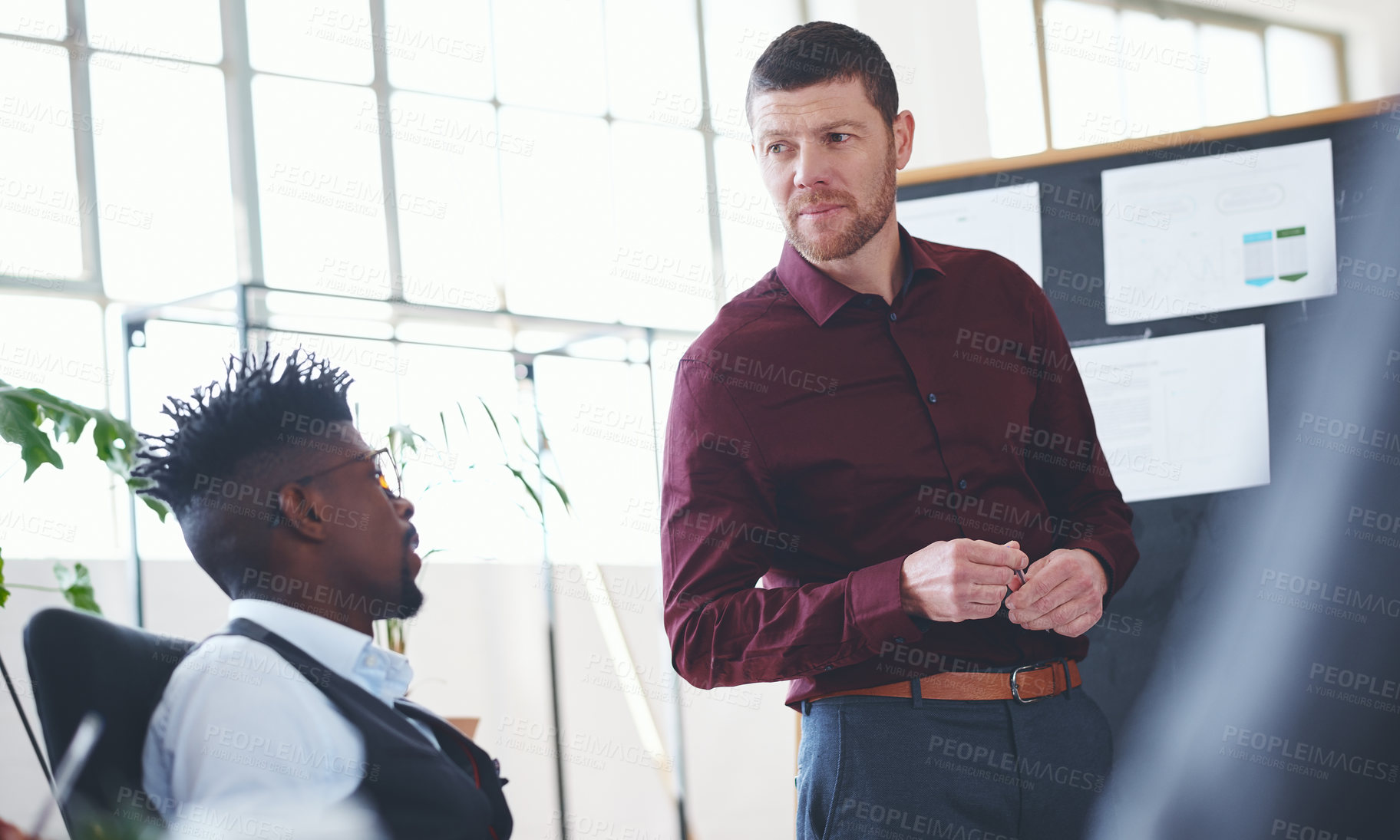 Buy stock photo Shot of a businessman giving a presentation to his colleagues in an office