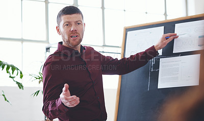 Buy stock photo Shot of a businessman giving a presentation in an office