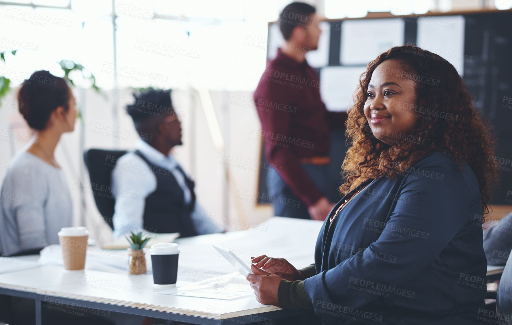 Buy stock photo Shot of a young businesswoman using a digital tablet during a meeting in an office