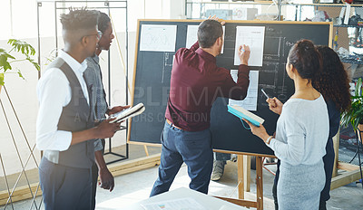 Buy stock photo Shot of a group of businesspeople discussing statistics