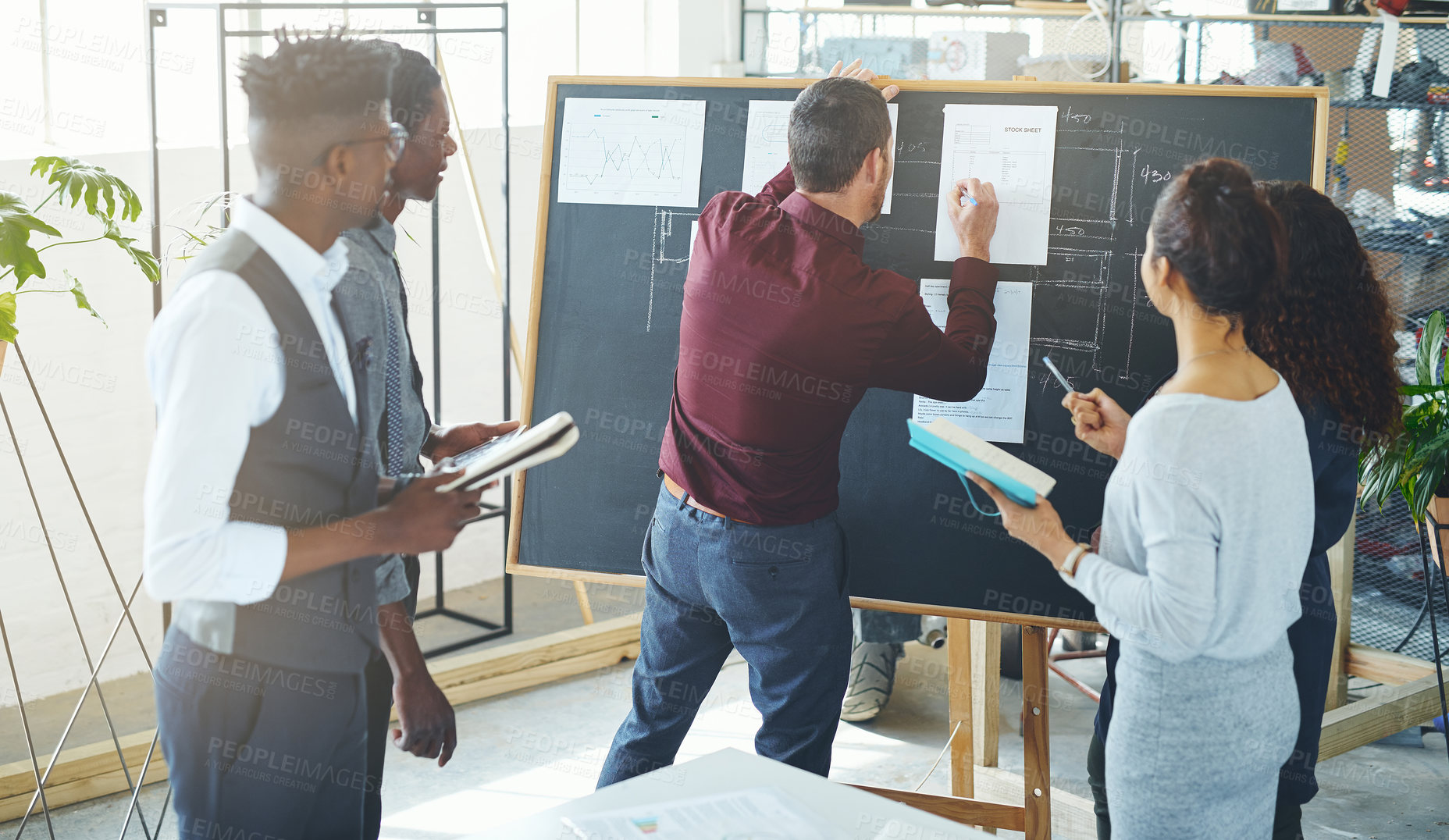 Buy stock photo Shot of a group of businesspeople discussing statistics