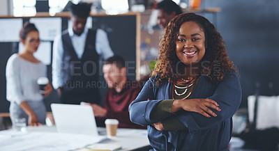 Buy stock photo Cropped portrait of an attractive young businesswoman standing with her arms folded with her colleagues in the background