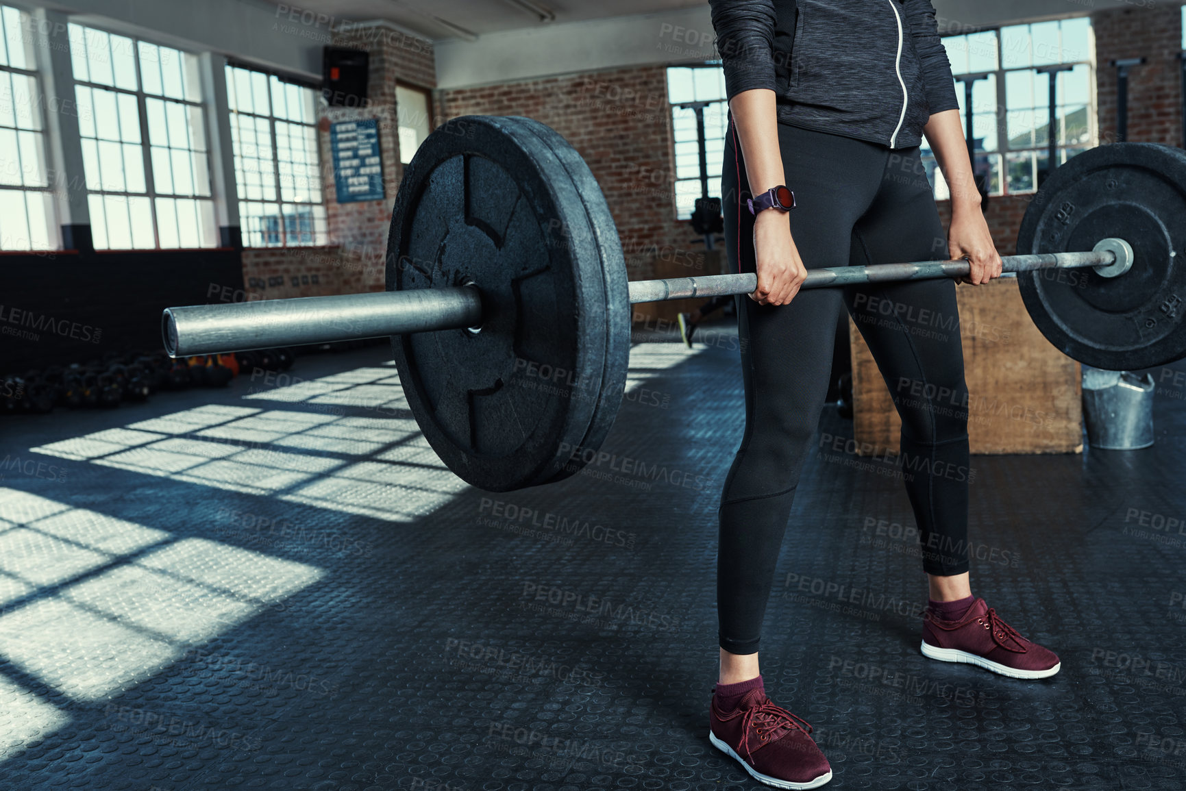 Buy stock photo Shot of an unrecognizable woman lifting weights in a gym