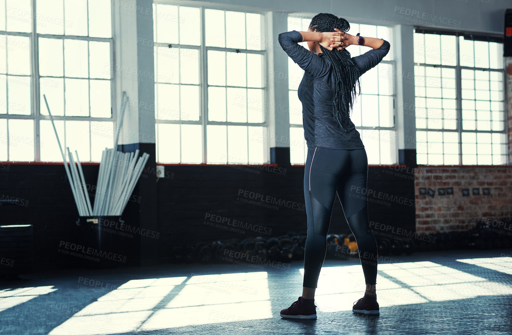 Buy stock photo Rearview shot of an unrecognizable woman in a gym