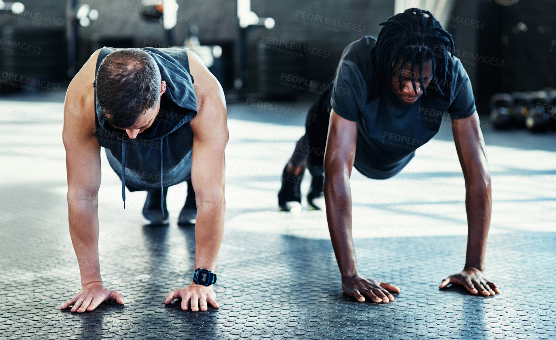 Buy stock photo Shot of young men doing push ups in a gym