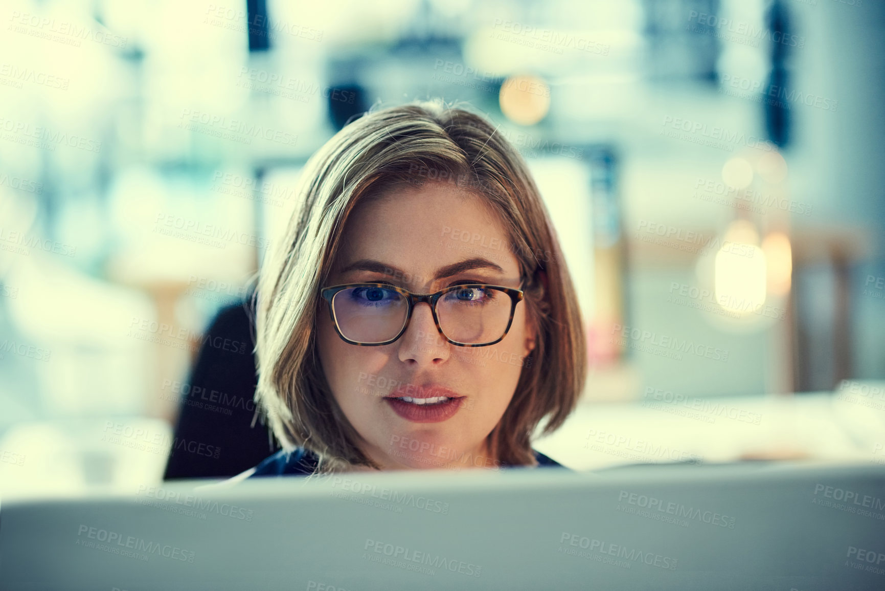 Buy stock photo Shot of a young businesswoman working late in an office