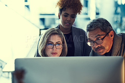 Buy stock photo Shot of a group of businesspeople working late in an office