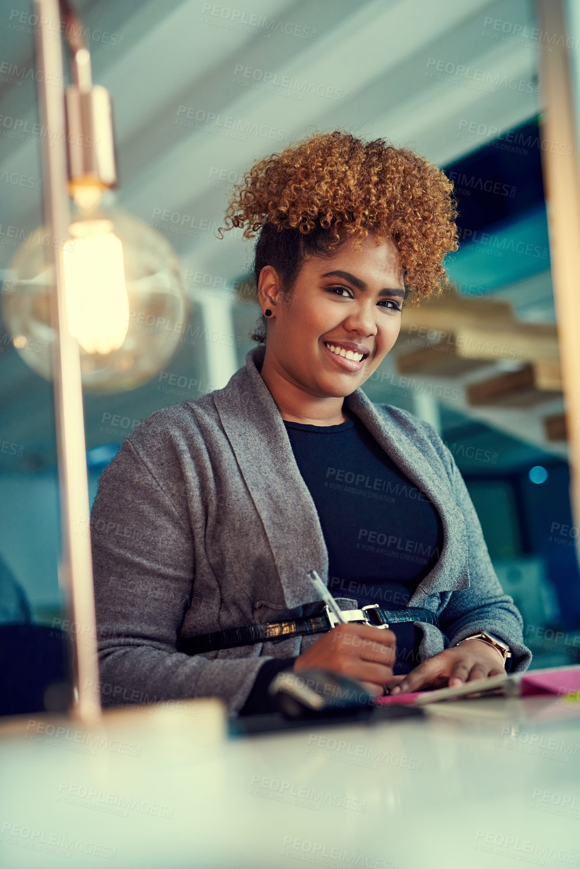 Buy stock photo Portrait of a young businesswoman working late in an office