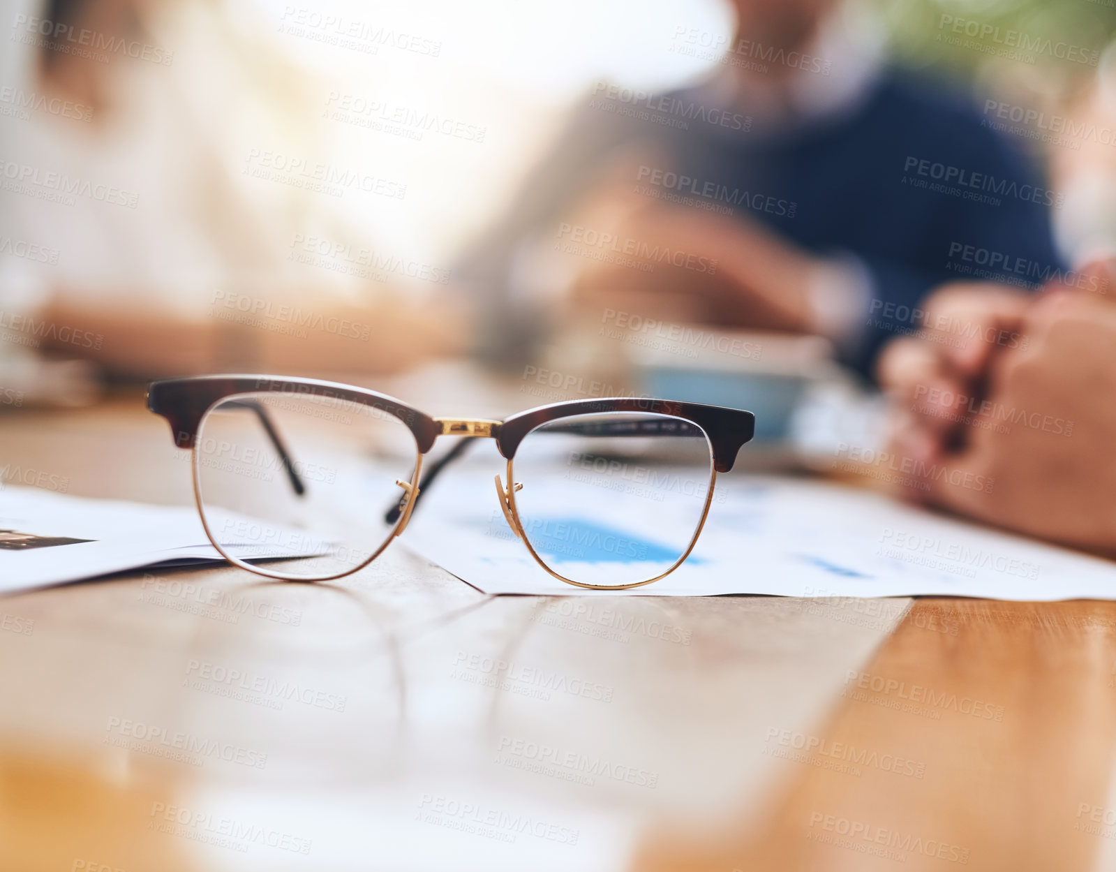Buy stock photo Shot of a pair of reading glasses on a table in the office