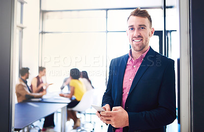Buy stock photo Business man, portrait and smartphone in office with team in background for corporate work and collaboration. Male professional, mobile or tech with colleagues meeting behind for new job or project