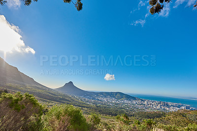 Buy stock photo Landscape of a mountain and city in South Africa. Wide angle of shrubs and wild bushes against a bright blue horizon of Cape Town. View of Lions Head, a popular travel destination near Table Mountain