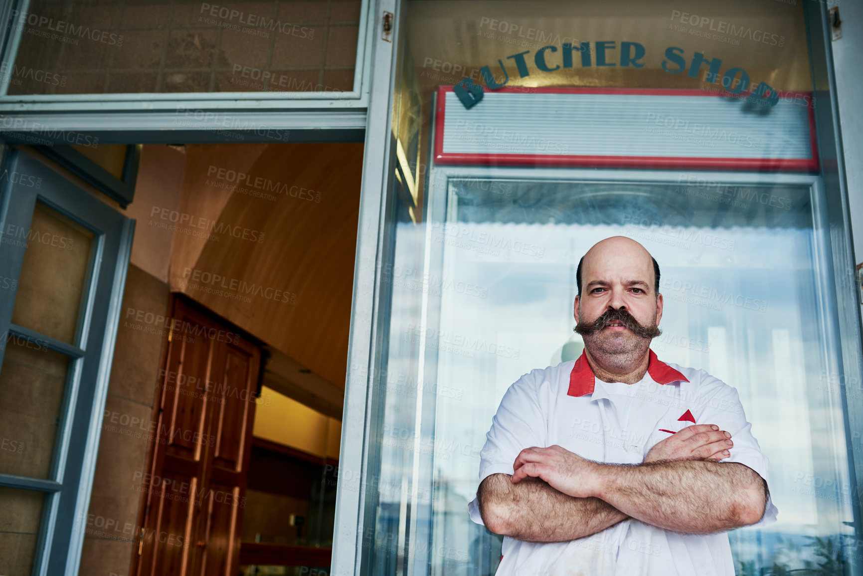 Buy stock photo Shot of a butcher at his store