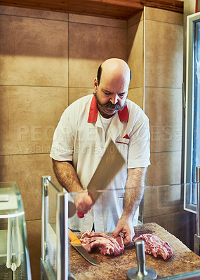 Buy stock photo Shot of a butcher at his store