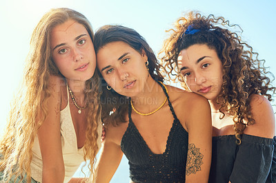 Buy stock photo Outdoor, portrait and group of friends for travel, vacation and summer holiday with hug in Spain. People, serious women or embrace by blue sky for adventure, connection or bonding together with pride