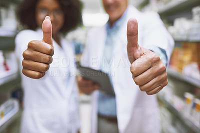 Buy stock photo Closeup of two unrecognizable people showing thumbs up with their hands in a pharmacy