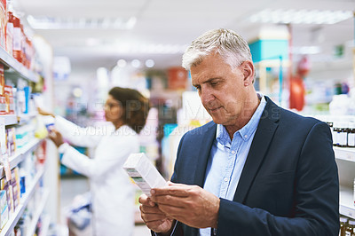 Buy stock photo Senior man shopping, reading on medicine or customer in pharmacy for retail healthcare pills or product. Information, businessman or mature customer searching for medication or medical drugs on shelf