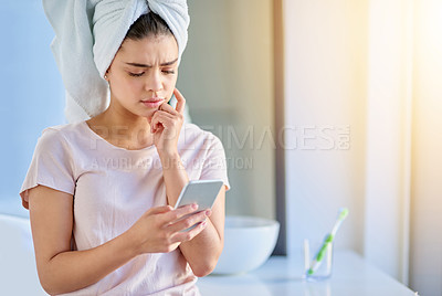 Buy stock photo Confused, woman and skincare with phone in bathroom for beauty treatment, update or research on facial. Tech, stress and person with anxiety at home for website, connection or online dermatology tips