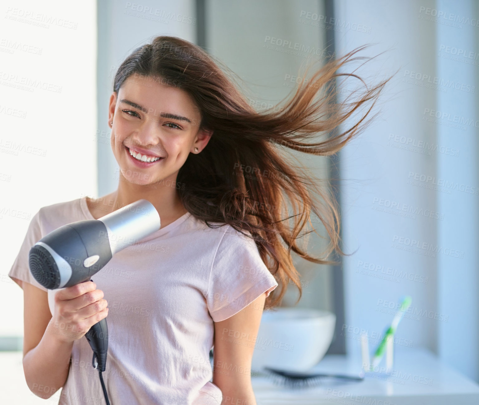 Buy stock photo Portrait, blow dryer and girl with smile in home, grooming and morning for beauty in bathroom. Happy, cosmetics tool or electric appliance for hairstyle, heat treatment or healthy texture in Spain