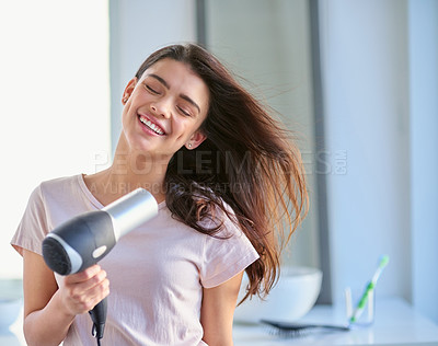 Buy stock photo Woman, appliance and hair dryer in home, grooming and morning for getting ready in bathroom. Female person, cosmetics and electric tool for hairstyle, volume and heat treatment for healthy texture