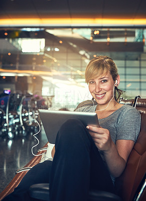 Buy stock photo Shot of a young woman using a tablet in an airport