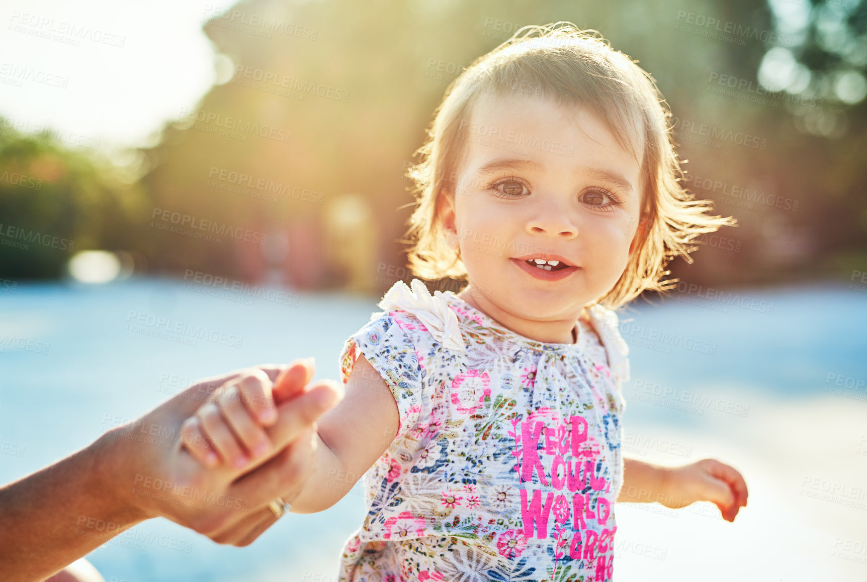 Buy stock photo Girl, baby and learning to walk in garden with holding hands, support and balance for development at family house. Child, toddler and steps for motor skills, growth and face with sunshine in backyard