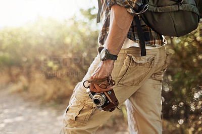 Buy stock photo Cropped shot of an unrecognizable man hiking with his camera in the mountains