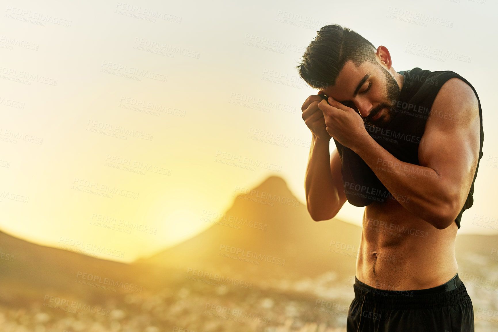 Buy stock photo Shot of a young man exercising outdoors