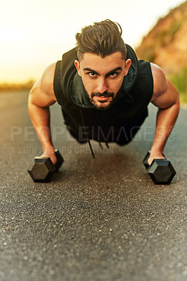 Buy stock photo Shot of a young man exercising outdoors