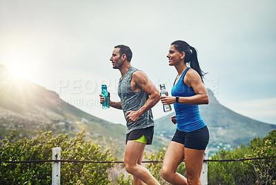 Buy stock photo Couple, people and smile with running for fitness or training, support and love in Brazil. Workout, exercise and outdoor with jogging for health, wellness and wellbeing in sunset with lens flare